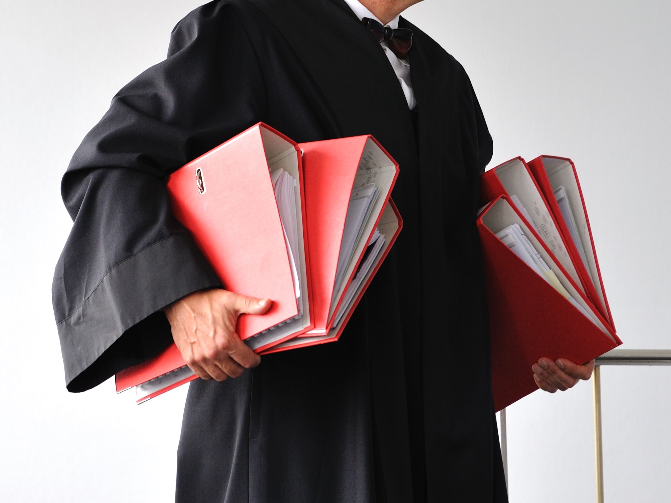 A man holding folders.